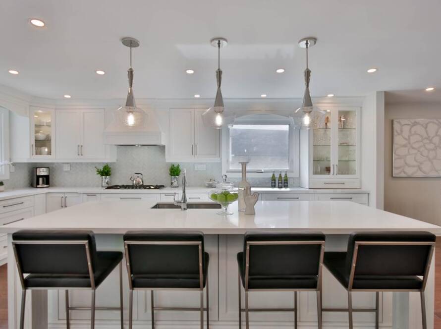 Remodeled kitchen with white cabinets and a large island