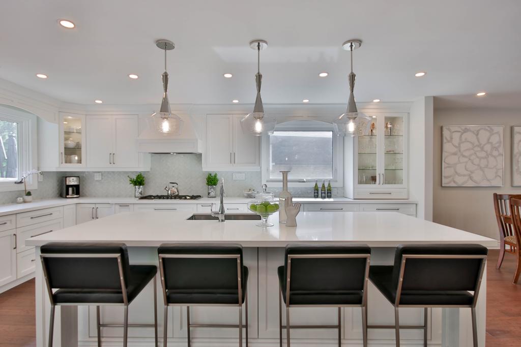 Remodeled kitchen with white cabinets and a large island