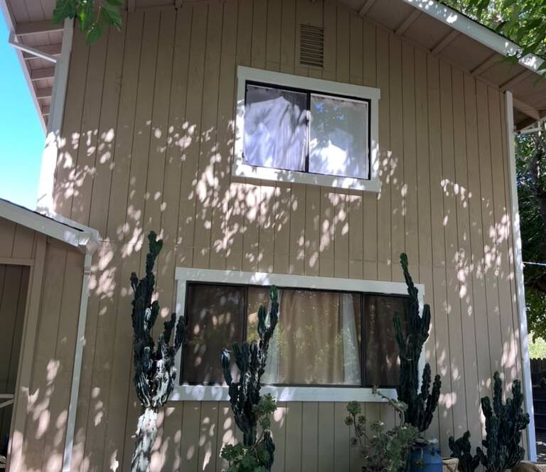 Two-story home exterior after a fresh coat of paint