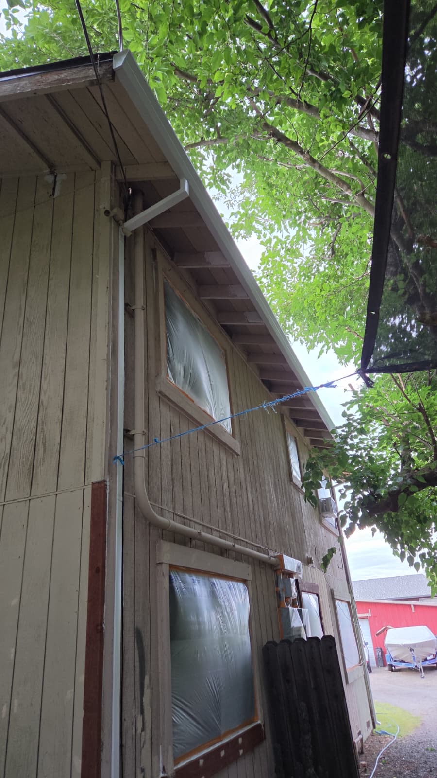 Weathered siding and brown window trim on the Vacaville house before painting