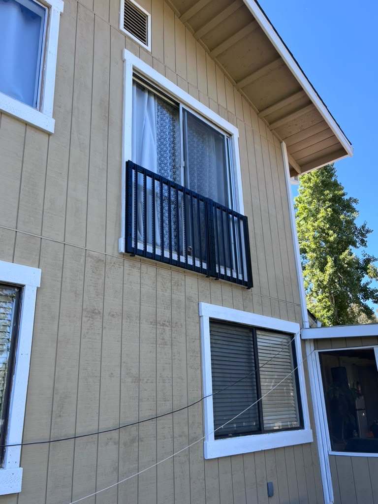 Painted siding with white window trim and new eaves